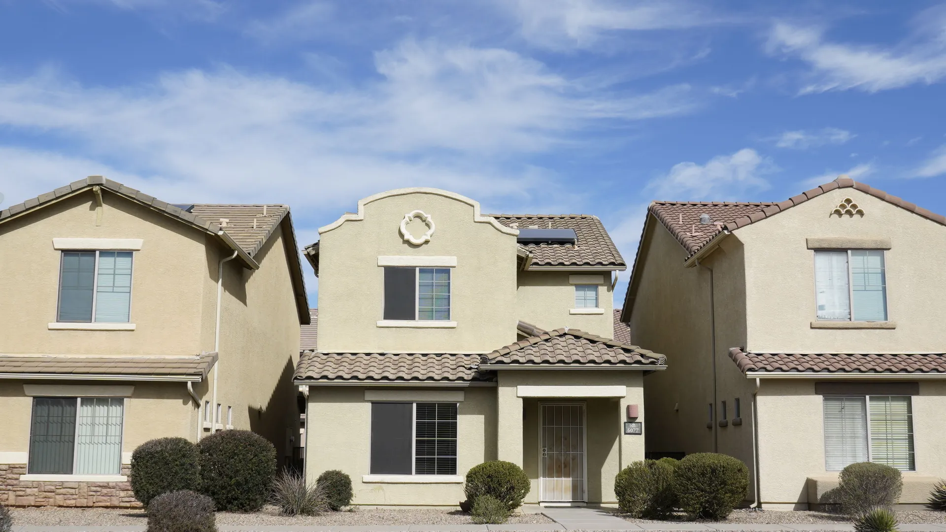 Row of two-story stucco homes on a residential street in Arizona